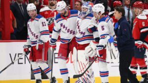New York Rangers goaltender Igor Shesterkin, third from left, is helped to the bench after he was injured during the second period of an NHL hockey game against the Washington Capitals, Friday, Oct. 9, 2026, in Washington. (Nick Wass/AP)