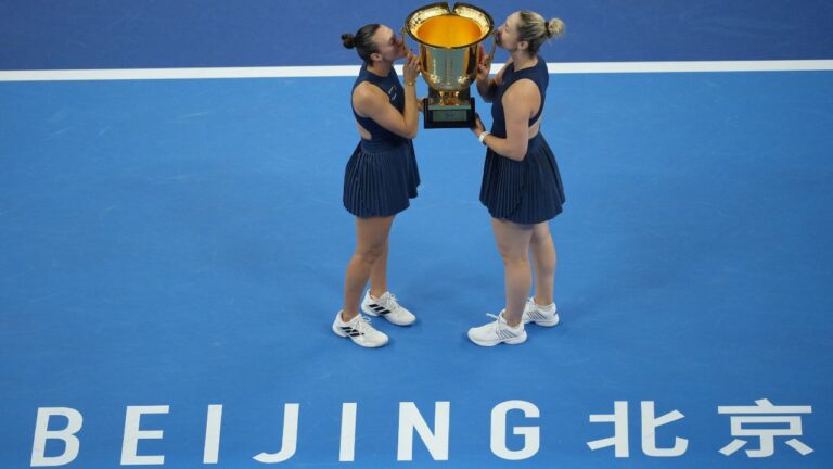 Gabriela Dabrowski, of Canada, and Luisa Stefani, of Brazil pose with the winners trophies after winning the women's doubles final match against Katerina Siniakova, of the Czech Republic, and Zhang Shuai, of China at the China Open tennis tournament in Beijing, Sunday, Oct. 11, 2026. (AP Photo/Andy Wong)