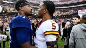 New York Giants quarterback Jameis Winston, left, hugs Washington Commanders head coach Dan Quinn after an NFL football game in Landover, Md., Sunday, Oct. 11, 2026. (AP Photo/Nick Wass)