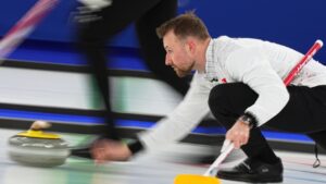 Switzerland's Yannick Schwaller competes during a men's curling bronze medal match between Norway and Switzerland, at the 2026 Winter Olympics, in Cortina d'Ampezzo, Italy, Friday, Feb. 20, 2026. (AP Photo/Fatima Shbair)