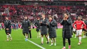 Freiburg's players walk in coats disappointed to their fans after losing the German Bundesliga soccer match between Bayer Leverkusen and SC Freiburg in Leverkusen, Germany, Sunday, Oct. 18, 2026. (AP Photo/Martin Meissner)
