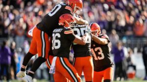 Cleveland Browns long snapper Rex Sunahara, left, and others pile on place kicker Andre Szmyt, second from right, after his game-winning field goal during the second half of an NFL football game against the Baltimore Ravens in Cleveland, Sunday, Oct. 18, 2026. (AP Photo/Sue Ogrocki)