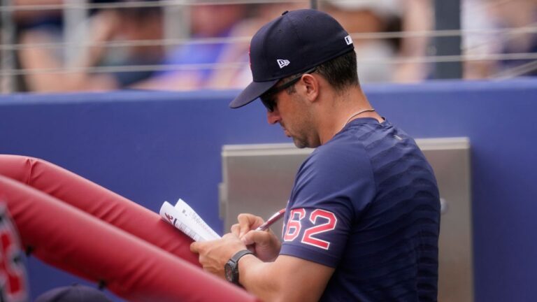 Boston Red Sox hitting coach Peter Fatse (62) takes notes in the dugout in the fourth inning during a spring training game against the Atlanta Braves at CoolToday Park, Sunday, April 3, 2022, in North Port, Fla. (Steve Helber/AP)