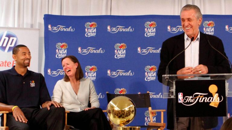 Miami Heat President Pat Riley, center, laughs as he talks to students at Paul Laurence Dunbar Elementary School, as from left Juwan Howard and Kathy Behrens listen, Wednesday, June 1, 2011, in Miami. (Alan Diaz/AP)