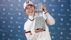 Yuri Yoshida of Japan celebrates with the winner's trophy following the final round of the LPGA BMW Ladies Championship at the Pine Beach Golf Links, in Haenam, South Korea, Sunday, Oct. 25, 2026. (AP Photo/Lee Jin-man)