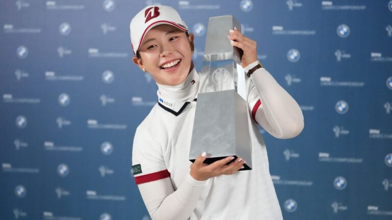 Yuri Yoshida of Japan celebrates with the winner's trophy following the final round of the LPGA BMW Ladies Championship at the Pine Beach Golf Links, in Haenam, South Korea, Sunday, Oct. 25, 2026. (AP Photo/Lee Jin-man)