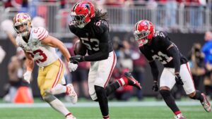 Atlanta Falcons linebacker Kendal Daniels (53) returns an interception as San Francisco 49ers' Christian McCaffrey (23) gives chase during the second half of an NFL football game in Atlanta, Sunday, Oct. 25, 2026. (AP Photo/Mike Stewart)