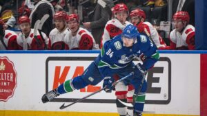 Vancouver Canucks' Linus Karlsson (94) and Carolina Hurricanes' Bradly Nadeau (29) vie for the puck during the first period of an NHL hockey game in Vancouver on Tuesday, Oct. 20, 2026. (Ethan Cairns/CP)