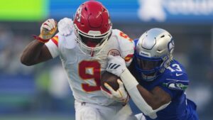 Kansas City Chiefs running back Kenneth Walker III (9) is stopped by Seattle Seahawks linebacker Ernest Jones IV (13) during the first half of an NFL football game in Seattle, Sunday, Oct. 25, 2026. (AP Photo/Lindsey Wasson)
