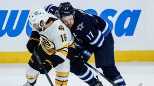 Winnipeg Jets' Adam Lowry (17)Êand Boston Bruins' Pavel Zacha (18) collide during first period NHL hockey action in Winnipeg on Friday, Oct. 2, 2026. (John Woods/CP)