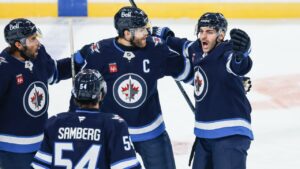 Winnipeg Jets' Alex Iafallo (left), Dylan Samberg (54), Adam Lowry (17)Êand Dylan DeMelo (2) celebrates DeMelo's goal against the Boston Bruins during first period NHL hockey action in Winnipeg on Friday, Oct. 2, 2026. (John Woods/CP)