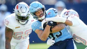 Toronto Argonauts wide receiver David Ungerer III (83) gets tackled by BC Lions defensive back Robert Carter Jr. (0) during first half CFL football action in Toronto, Saturday, Oct. 3, 2026. (Nathan Denette/THE CANADIAN PRESS)