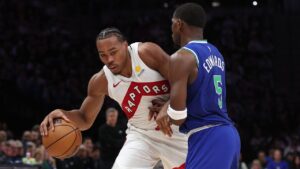 Toronto Raptors forward Scottie Barnes, left, drives while being defended by Minnesota Timberwolves guard Anthony Edwards (5) during the second half of an NBA basketball game, Sunday, Oct. 25, 2026, in Minneapolis. (Bailey Hillesheim/AP Photo)