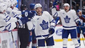 Toronto Maple Leafs defenseman Nick Blankenburg, front right, is congratulated as he passes the team box after scoring against the Colorado Avalanche in the first period of an NHL hockey game. (David Zalubowski/AP)