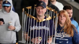 A Milwaukee Brewers fan dressed as the Commissioner's Trophy arrives for a rally during the baseball team's World Series parade, Friday, Oct. 30, 2026, in Milwaukee. (Nam Huh/AP)
