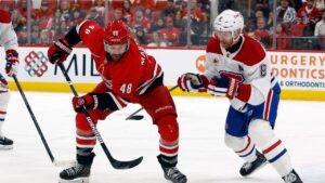 Carolina Hurricanes' Jordan Martinook (48) battles with Montréal Canadiens' Mike Matheson (8) during the second period of an NHL hockey game in Raleigh, N.C., Sunday, March 29, 2026. (Karl DeBlaker/AP Photo)
