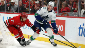 Vancouver Canucks' Jonathan Lekkerimäki (88) controls the puck with Carolina Hurricanes' Logan Stankoven (22) nearby during the first period of an NHL hockey game in Raleigh, N.C., Thursday, Oct. 8, 2026. (Karl DeBlaker/AP)