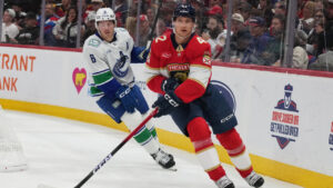 Florida Panthers defenseman Gustav Forsling (42) skates with the puck as Vancouver Canucks right wing Brock Boeser (6) defends during the first period of an NHL hockey game, Thursday, Oct. 15, 2026, in Sunrise, Fla. (Lynne Sladky/AP)