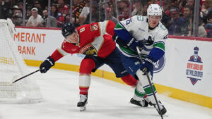 Vancouver Canucks defenceman Elias Pettersson (25) skates with the puck as Florida Panthers left wing Brady Tkachuk (8) defends during the second period of an NHL hockey game, Thursday, Oct. 15, 2026, in Sunrise, Fla. (Lynne Sladky/AP)