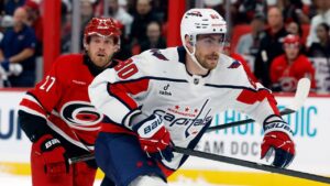 Washington Capitals' Pierre-Luc Dubois (80) chases the puck with Carolina Hurricanes' Nikolaj Ehlers (27) nearby during the first period of an NHL hockey game in Raleigh, N.C., Friday, Oct. 2, 2026. (Karl DeBlaker/AP Photo)