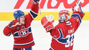 Montreal Canadiens goaltender Jacob Fowler (32) celebrates with teammate Cole Caufield (13) following the team's shootout win over the Detroit Red Wings in an NHL hockey game in Montreal on Saturday, Oct. 10, 2026. (Graham Hughes/CP)
