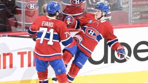 Montreal Canadiens' Cole Caufield (13) celebrates with teammate Jake Evans (71) after scoring against the Buffalo Sabres during overtime NHL action in Montreal on Saturday, Oct. 17, 2026. (Graham Hughes/CP)