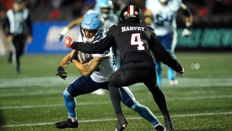 Toronto Argonauts' David Ungerer III (83) runs into Ottawa Redblacks' Ahmari Harvey (4) during first half CFL action in Ottawa, Friday, Oct. 16, 2026. (Adrian Wyld/CP)