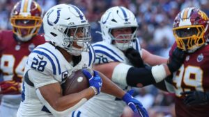 Indianapolis Colts running back Jonathan Taylor (28) runs into the end zone to scores his side's second touchdown during an NFL football game against Washington Commanders in London, Sunday, Oct. 4, 2026. (Ian Walton/AP)