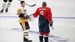 Pittsburgh Penguins centre Sidney Crosby (87) meets with Washington Capitals left wing Alex Ovechkin (8) during warmups before an NHL hockey game, Sunday, April 12, 2026, in Washington. (Nick Wass/AP)