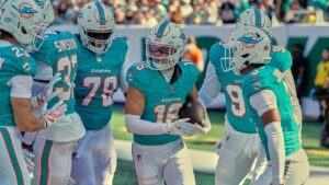 Miami Dolphins safety Michael Taaffe celebrates his interception against the New York Jets with teammates in the first half of an NFL game in East Rutherford, N.J., Sunday, Oct. 25, 2026. (AP/Seth Wenig)
