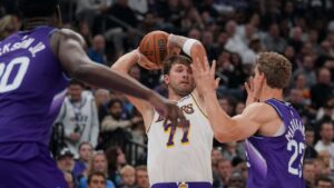 Los Angeles Lakers forward/guard Luka Doncic (77) looks to pass the ball as Utah Jazz forward/centre Lauri Markkanen (23) blocks during the first half of an NBA basketball game Sunday, Oct. 25, 2026, in Salt Lake City. (Bethany Baker/AP Photo)