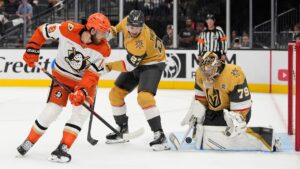 Anaheim Ducks left wing A.J. Greer (18) attempts a shot on Vegas Golden Knights goaltender Carter Hart (79) during the first period of an NHL hockey game Friday, Oct. 2, 2026, in Las Vegas. (John Locher/AP Photo)