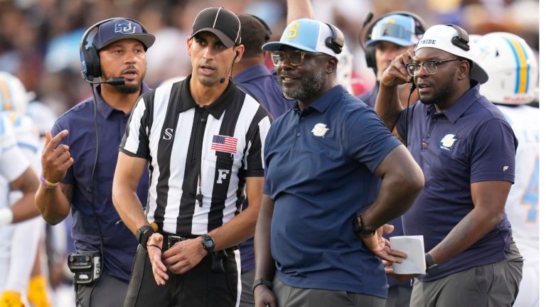Southern head coach Marshall Faulk, center right, talks with an official during the first half of an NCAA college football game against Houston in Houston, Saturday, Sept. 12, 2026. (Ashley Landis/AP Photo)