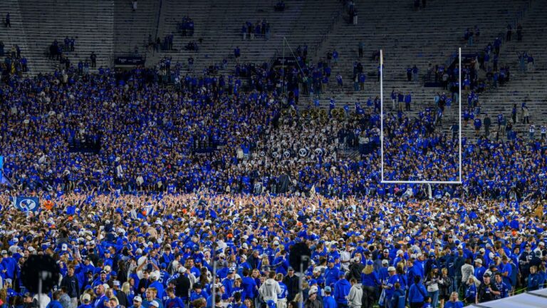 BYU fans storm the field after beating Notre Dame in an NCAA college football game, Saturday, Oct. 17, 2026, in Provo, Utah. (Tyler Tate/AP Photo)