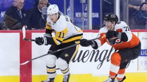 Pittsburgh Penguins' Filip Hallander, left, and Philadelphia Flyers' Tyson Foerster battle for the puck during the first period of an NHL hockey game, Tuesday, Oct. 28, 2025, in Philadelphia. (Matt Slocum/AP)