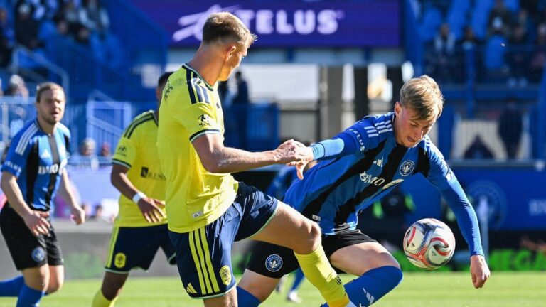 Nashville SC's Sam Surridge, left, challenges CF Montreal's Hennadii Synchuk during first half MLS soccer action in Montreal, on Saturday, Oct. 24, 2026. (Graham Hughes/CP)