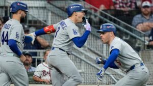 Los Angeles Dodgers' Andy Pages (44), Enrique Hernández, center, and Freddie Freeman, right, celebrate after Hernandez hit a two-run home run during the fourth inning in Game 3 of baseball's National League Division Seriesa against the Atlanta Braves, Tuesday, Oct. 6, 2026, in Atlanta. (Brynn Anderson/AP)