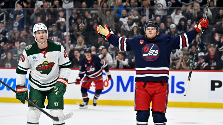 Winnipeg Jets' Cole Perfetti (91) celebrates his goal against the Minnesota Wild beside Blake Coleman (20) during second period NHL hockey action in Winnipeg on Tuesday, Oct. 13, 2026. (Fred Greenslade/CP)