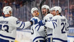 Toronto Maple Leafs' Darren Raddysh (43), Teddy Blueger (73), Zack MacEwan (19) and Brandon Duhaime (24) celebrate a goal against the Edmonton Oilers during third period NHL hockey action in Edmonton on Saturday, Oct. 24, 2026. (Codie McLachlan/THE CANADIAN PRESS)