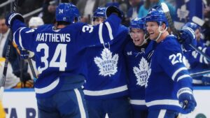 Toronto Maple Leafs' Gavin McKenna (second right) celebrates his goal against the Nashville Predators with Auston Matthews, left to right, Chris Tanev and Jake McCabe during second period NHL hockey action in Toronto on Tuesday, Oct. 6, 2026. (Nathan Denette/CP)