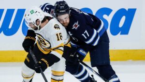 Winnipeg Jets' Adam Lowry (17)Êand Boston Bruins' Pavel Zacha (18) collide during first period NHL hockey action in Winnipeg on Friday, Oct. 2, 2026. (John Woods/THE CANADIAN PRESS)