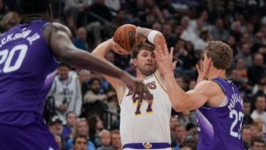 Los Angeles Lakers guard Luka Doncic (77) looks to pass the ball as Utah Jazz forward Lauri Markkanen (23) blocks during the first half of an NBA basketball game Sunday, Oct. 25, 2026, in Salt Lake City. (Bethany Baker/AP)
