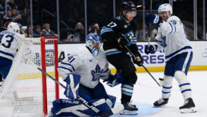 Utah Mammoth centre Barrett Hayton (27) looks to tip the puck past Toronto Maple Leafs goaltender Anthony Stolarz (41) during the third period of an NHL hockey game, Tuesday, Oct. 13, 2026, in Salt Lake City. (Tyler Tate/AP)