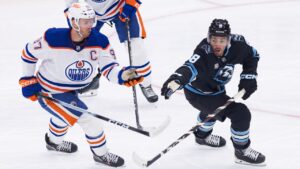 Utah Mammoth centre Nick Schmaltz (8) stops the puck against Edmonton Oilers centre Connor McDavid (97) during the first period of an NHL hockey game Saturday, Oct. 17, 2026, in Salt Lake City. (Melissa Majchrzak/AP Photo)