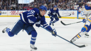 Toronto Maple Leafs' Gavin McKenna (92) shoots as Buffalo Sabres' Owen Power (25) defends during second period NHL hockey action in Toronto on Thursday, Oct. 15, 2026. (Nathan Denette/CP)