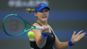 Mirra Andreeva, of Russia, returns a ball to Nikola Bartunkova, of the Czech Republic during the semifinals of the women's singles match at the China Open tennis tournament in Beijing, Saturday, Oct. 10, 2026. (Achmad Ibrahim/AP)