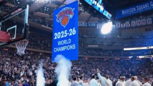 New York Knicks centre Karl-Anthony Towns waves as the Knicks 2025-26 World Champions banner is raised before an NBA basketball game between the New York Knicks and the Philadelphia 76ers Tuesday, Oct. 20, 2026, in New York. (Frank Franklin II/AP)