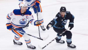 Utah Mammoth centre Nick Schmaltz (8) stops the puck against Edmonton Oilers center Connor McDavid (97) during the first period of an NHL hockey game Saturday, Oct. 17, 2026, in Salt Lake City. (Melissa Majchrzak/AP)