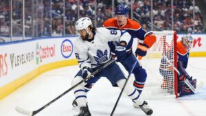 Edmonton Oilers' Connor Murphy (5) defends against Toronto Maple Leafs' Kirill Marchenko (86) during first period NHL hockey action in Edmonton on Saturday, Oct. 24, 2026. (Codie McLachlan/CP Photo)