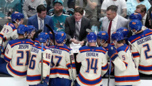 Edmonton Oilers head coach Mike Babcock, centre, talks with his players during a timeout in the third period of an NHL hockey game against the San Jose Sharks in San Jose, Calif., Saturday, Oct. 10, 2026. (Tony Avelar/AP)